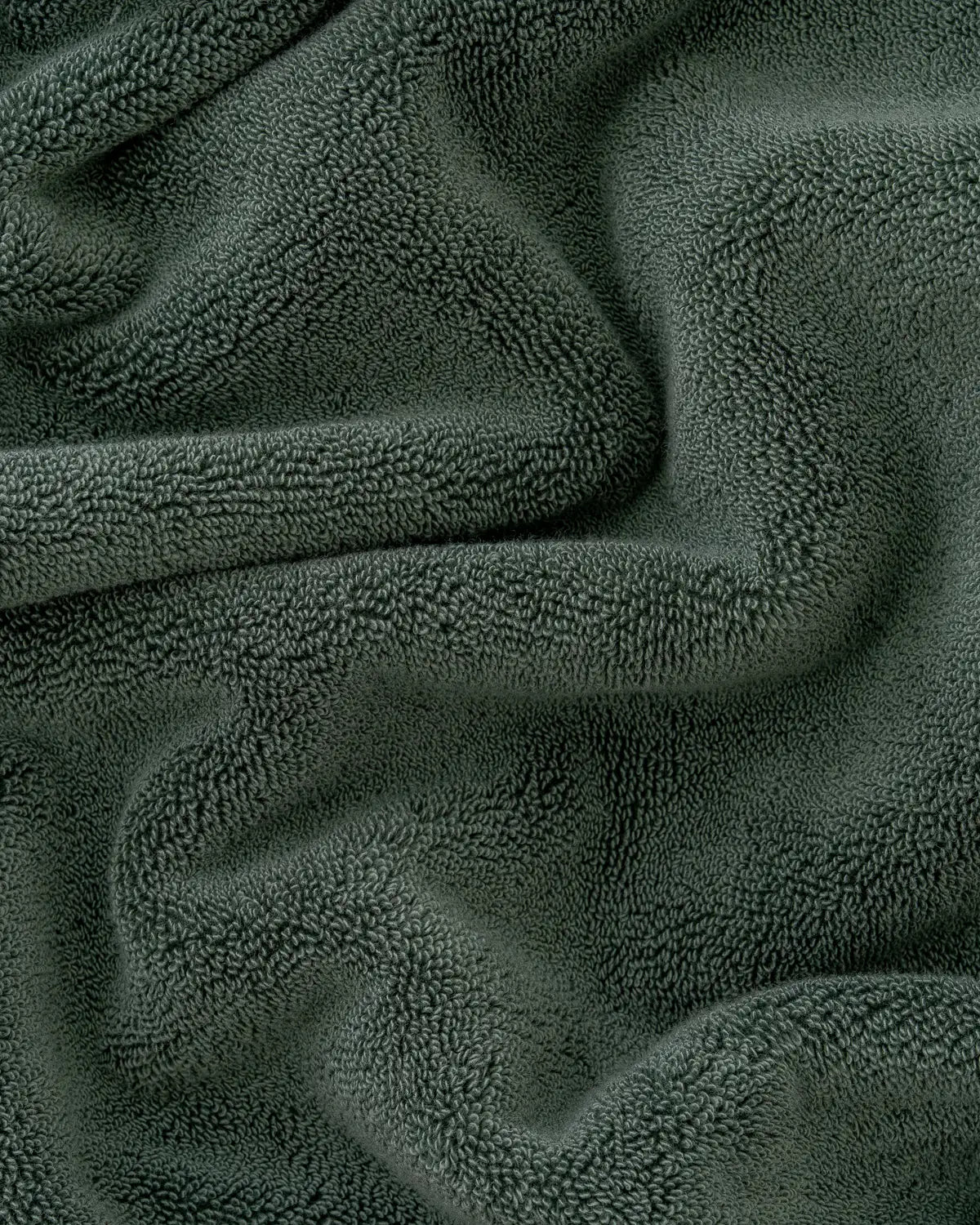 Close-up of pine green classic Turkish bath towel textured fabric