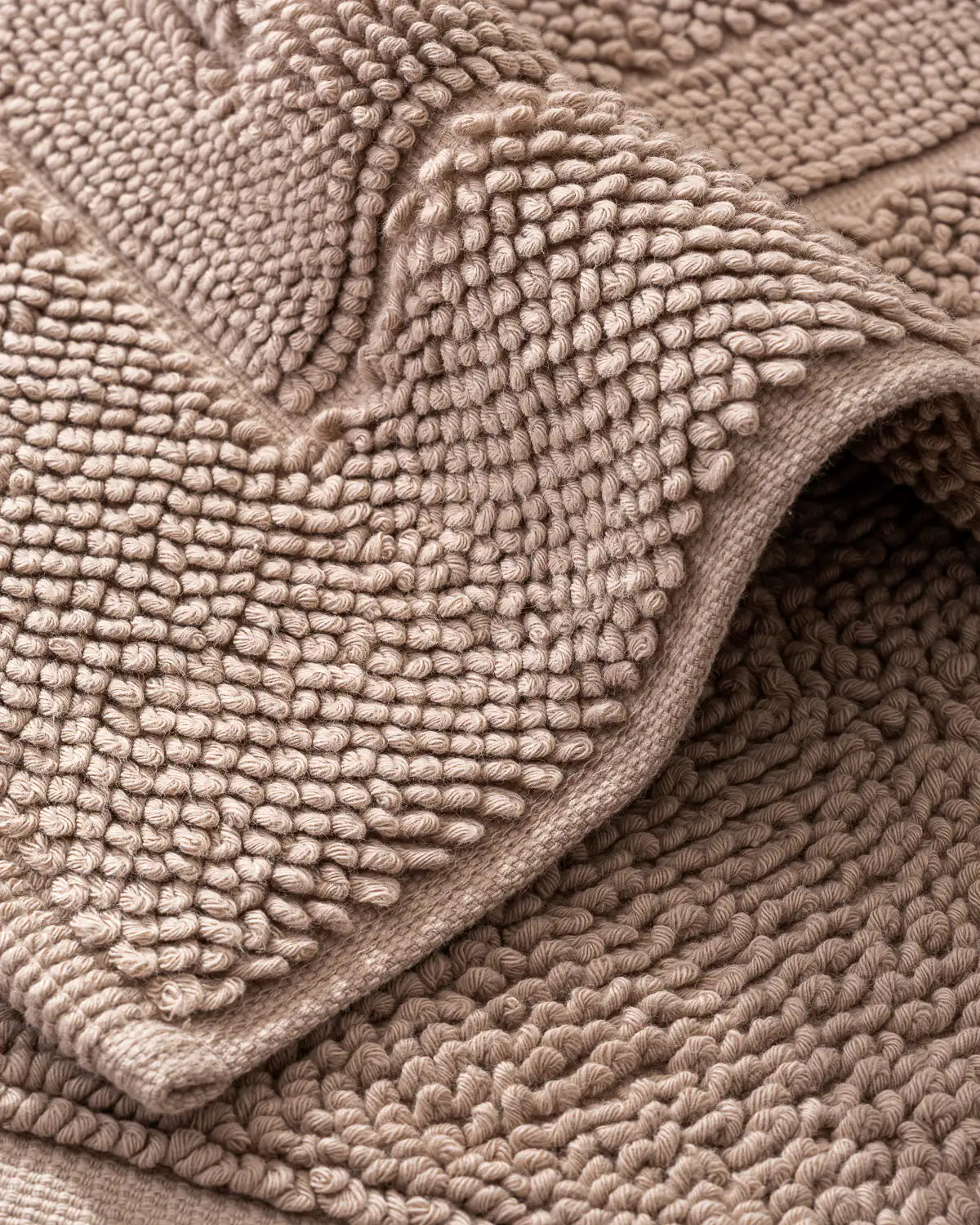 Close-up of a textured sandshell cotton bath rug