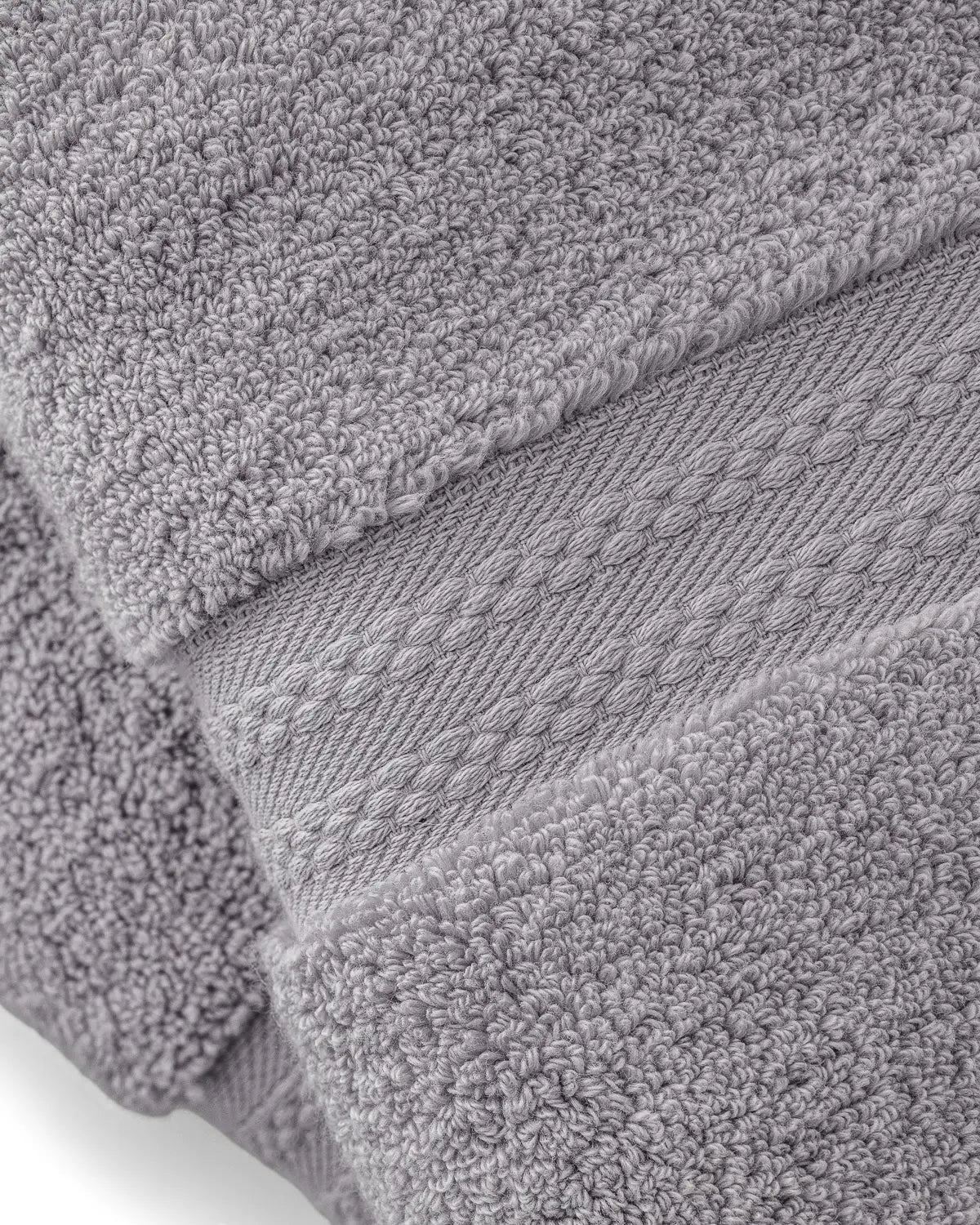 Stack of opal gray ultrasoft premium cotton towels with textured surface