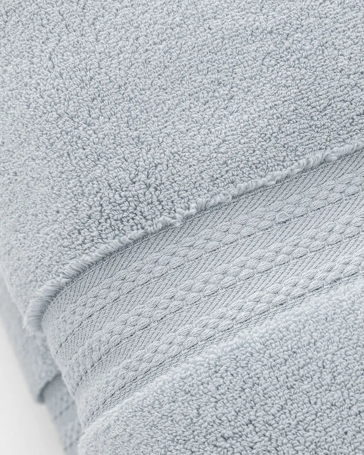Close-up of a sky blue ultrasoft cotton towel with textured surface