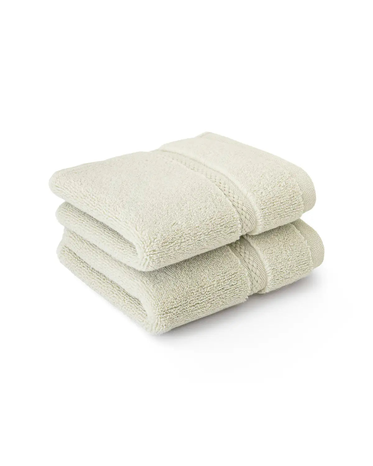 Two folded jade-colored ultrasoft cotton washcloths on a white background.