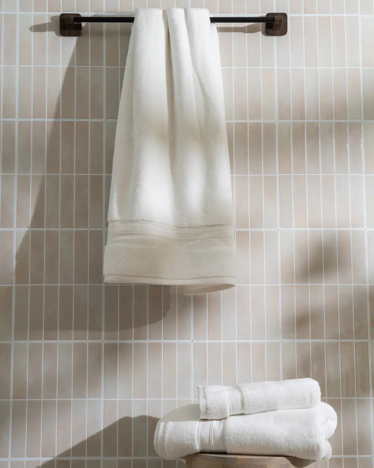 Modal cotton Turkish towel hanging on a towel rack against a tiled bathroom wall.
