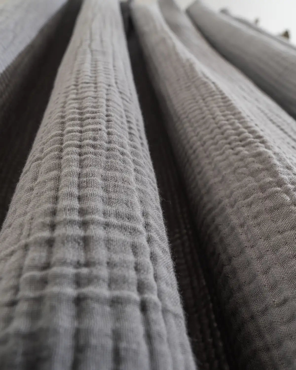 Close-up of an opal gray shower curtain made from Turkish cotton.