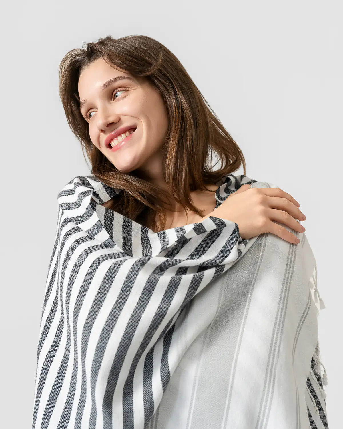 A woman wrapped in an ultra-lightweight multi-purpose beach towel.