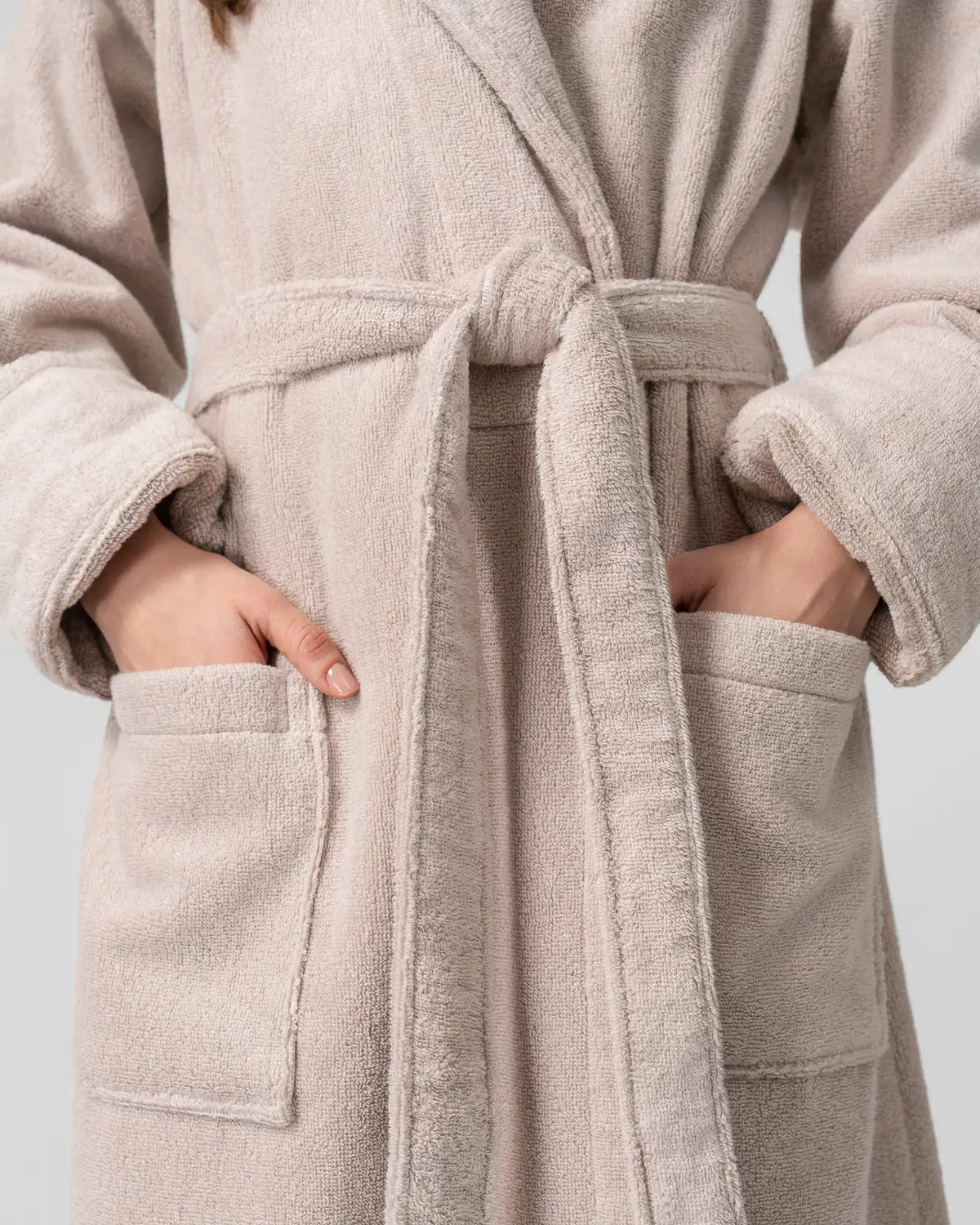 Person wearing a sandshell UltraSoft Premium Cotton High-Volume Bathrobe made from Turkish cotton